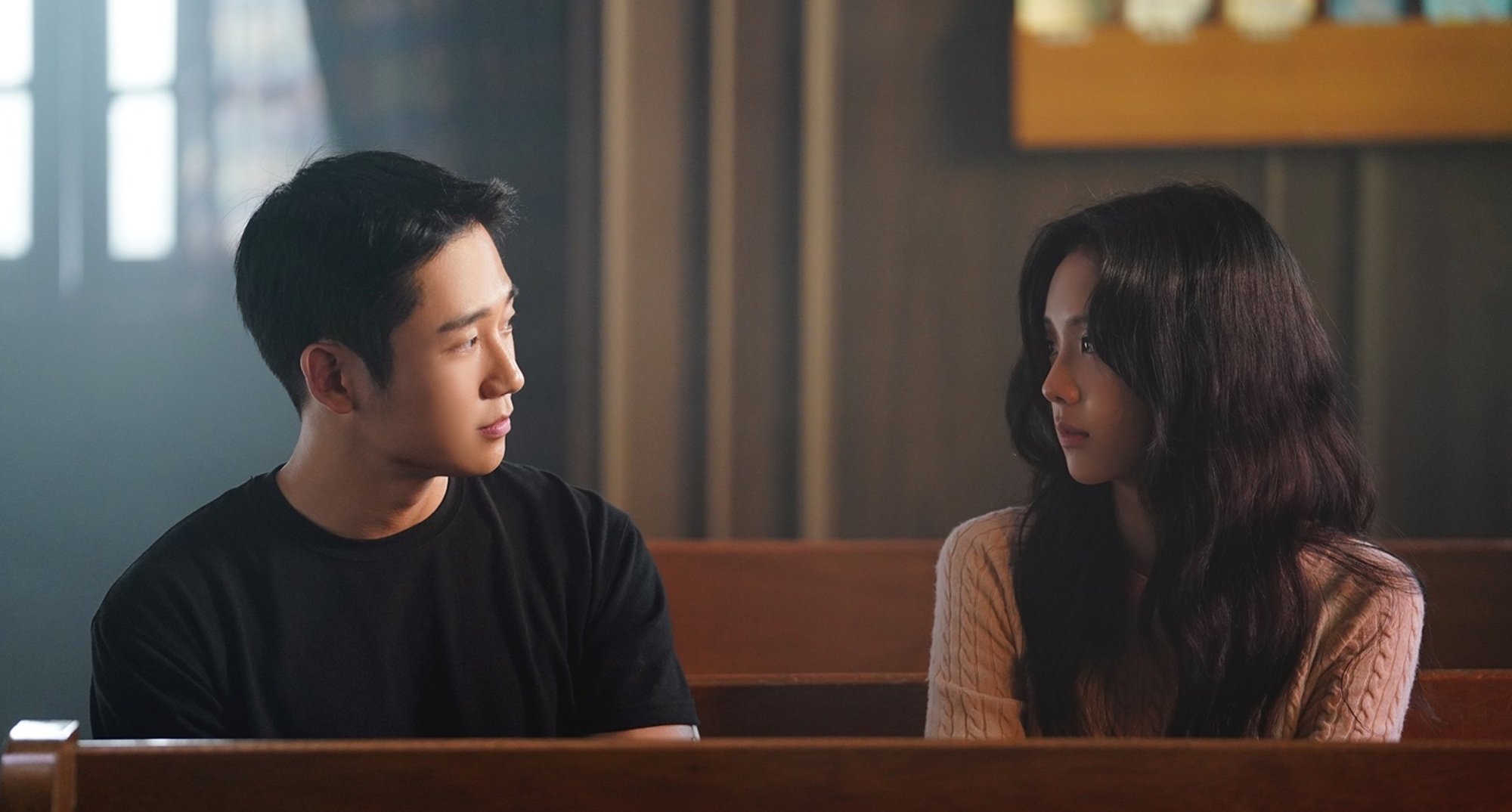 Actor Jung Hae-in and Jisoo in 'Snowdrop' K-drama staring at each other in church.
