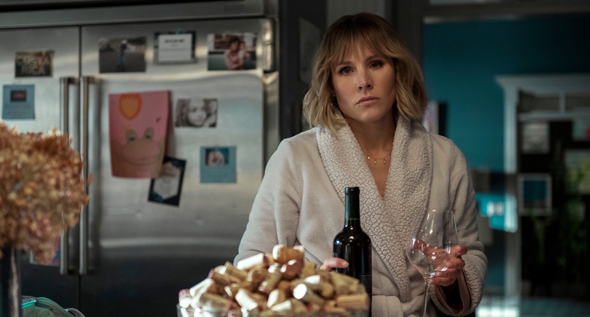 Actor Kristen Bell as Anna in 'The Woman in the House Across the Street From the Girl in the Window' wearing bathrobe in kitchen.