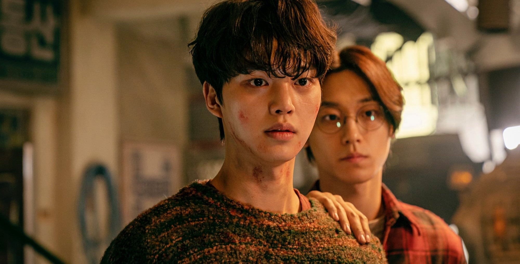 Actor Song Kang as Hyun-soo in 'Sweet Home' standing in front of other character.