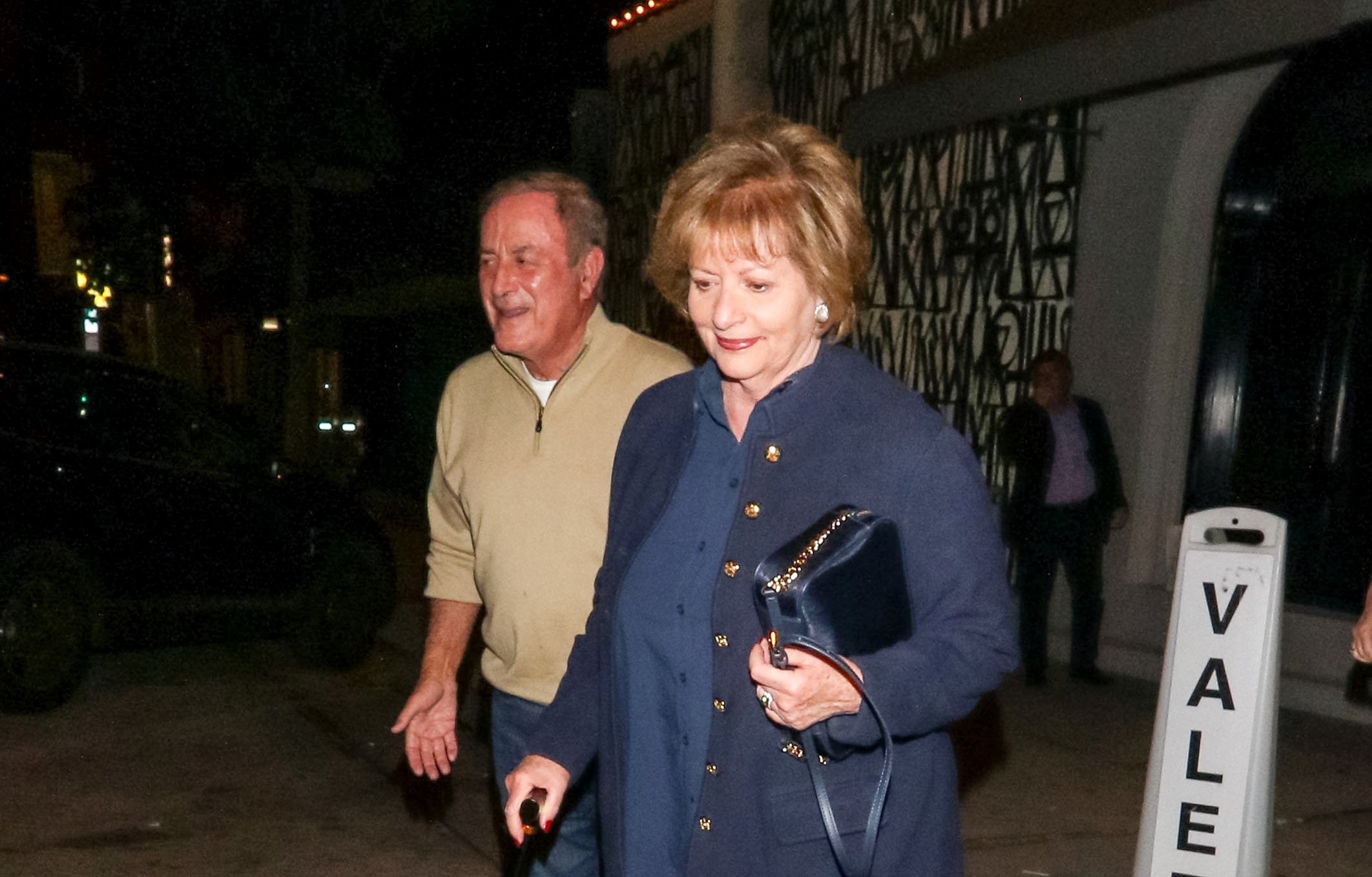 Al Michaels and his wife, Linda, leaving a restaurant in Los Angeles