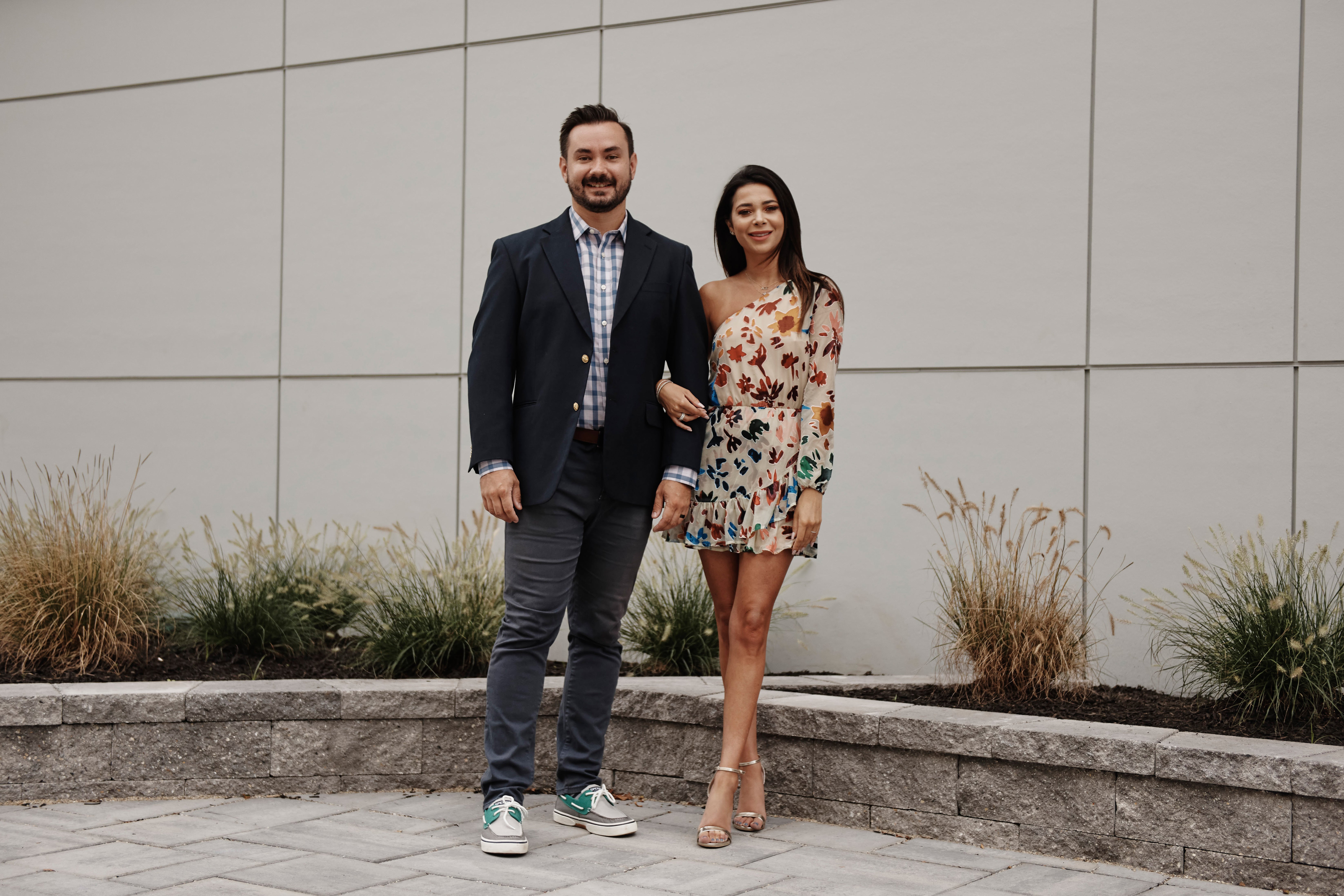Chris, wearing jeans and a blazer, and Alyssa, wearing a short floral-pattered dress, from 'Married at First Sight' Season 14