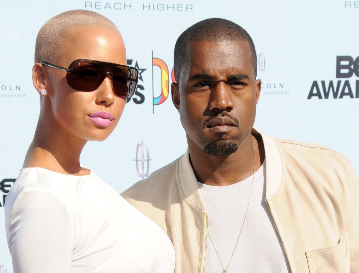 Amber Rose and Kanye West pose together at an event.