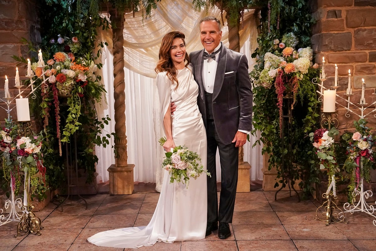 'The Young and the Restless' actor Amelia Heinle in a white silk wedding dress, and Richard Burgi in a grey tuxedo.