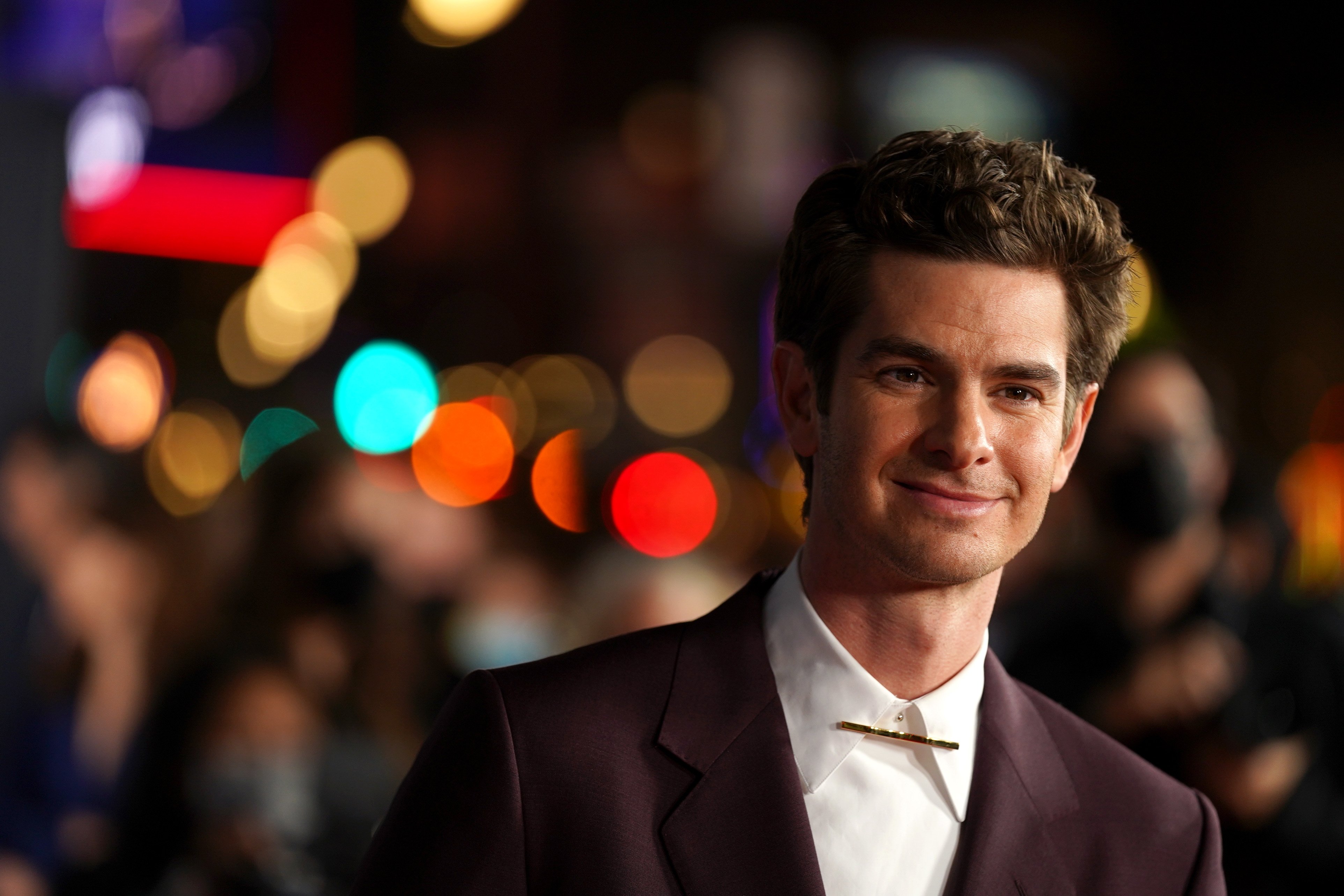 'Spider-Man: No Way Home' star Andrew Garfield wears a maroon blazer over a white button-up shirt.