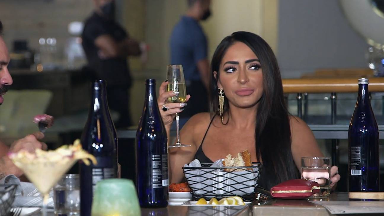Angelina Larangeira holds a glass of wine and looks left in the 'Hollywood Shore' episode of 'Jersey Shore: Family Vacation' Season 5