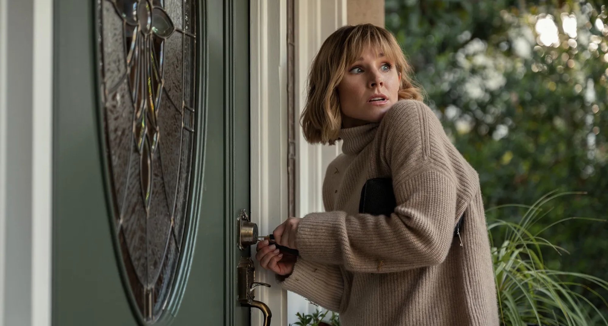 Anna from 'The Woman in the House Across the Street from the Girl in the Window' opening her front door.