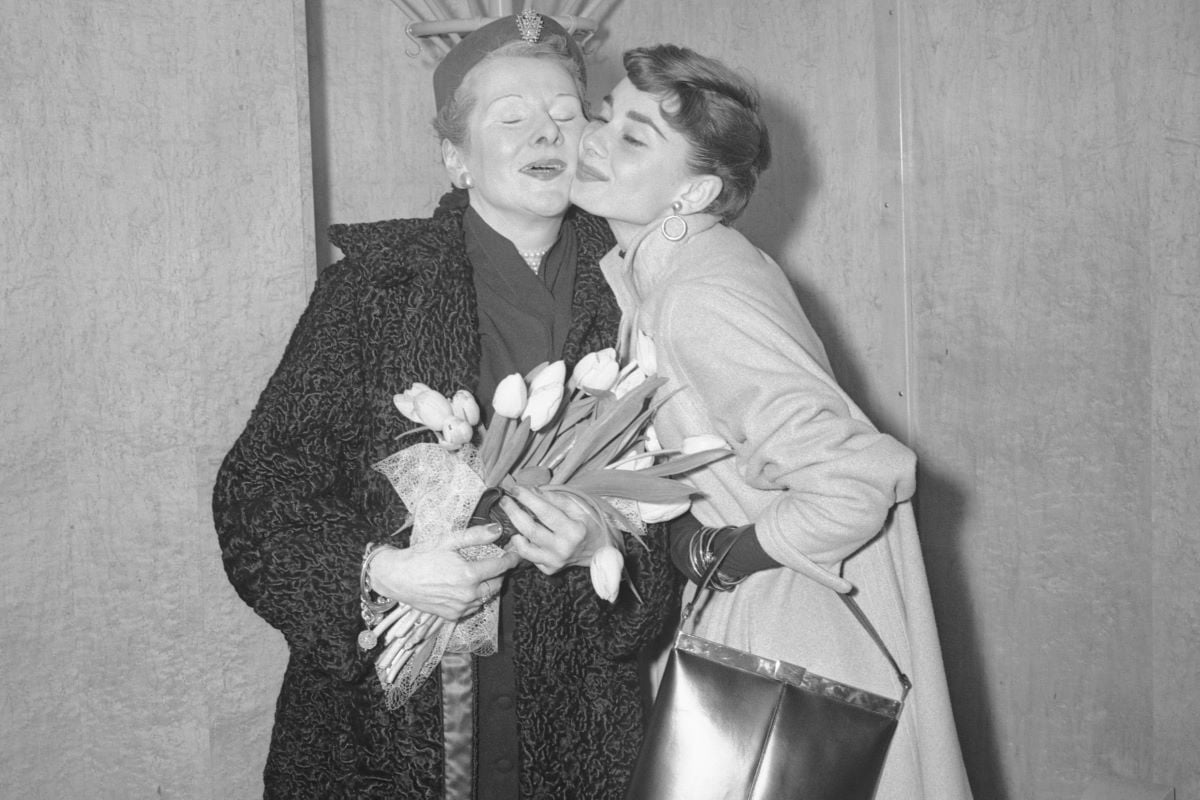 Ella van Heemstra, holding a bouquet, and daughter, Audrey Hepburn, pose cheek-to-cheek.