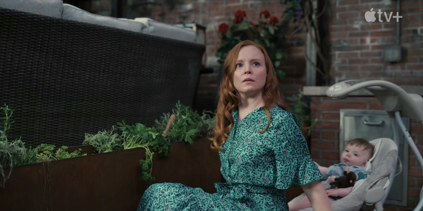 Lauren Ambrose wearing a green dress while working in her flower bed as Dorothy Turner in a production still from Servant Season 3.