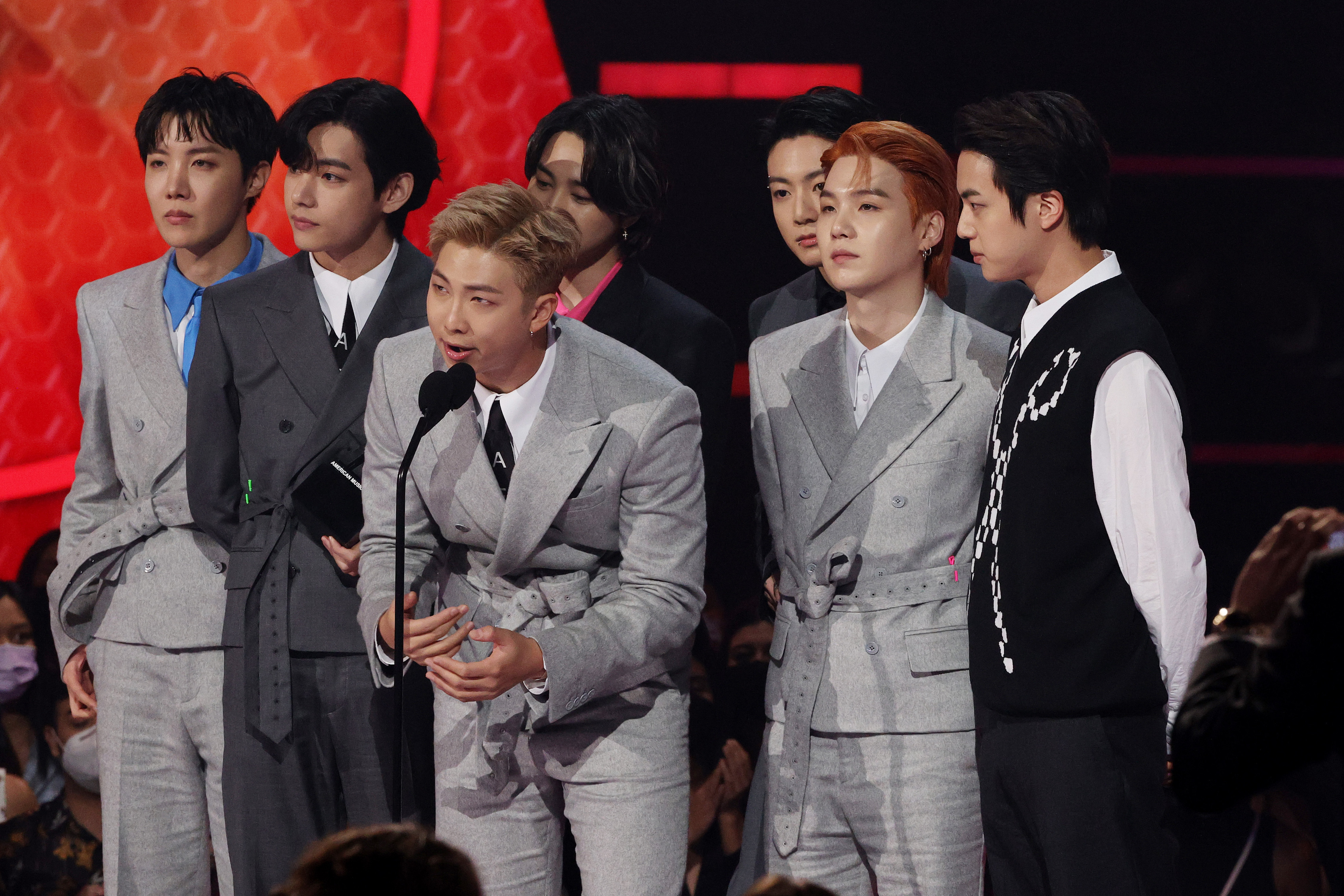 J-Hope, V, RM, Jimin, Suga, and Jungkook of BTS accept the Artist of the Year award onstage during the 2021 American Music Awards