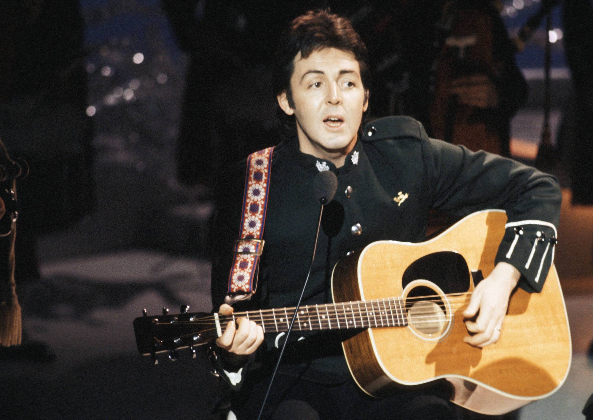 Beatles songwriter Paul McCartney. plays guitar and sings with Wings