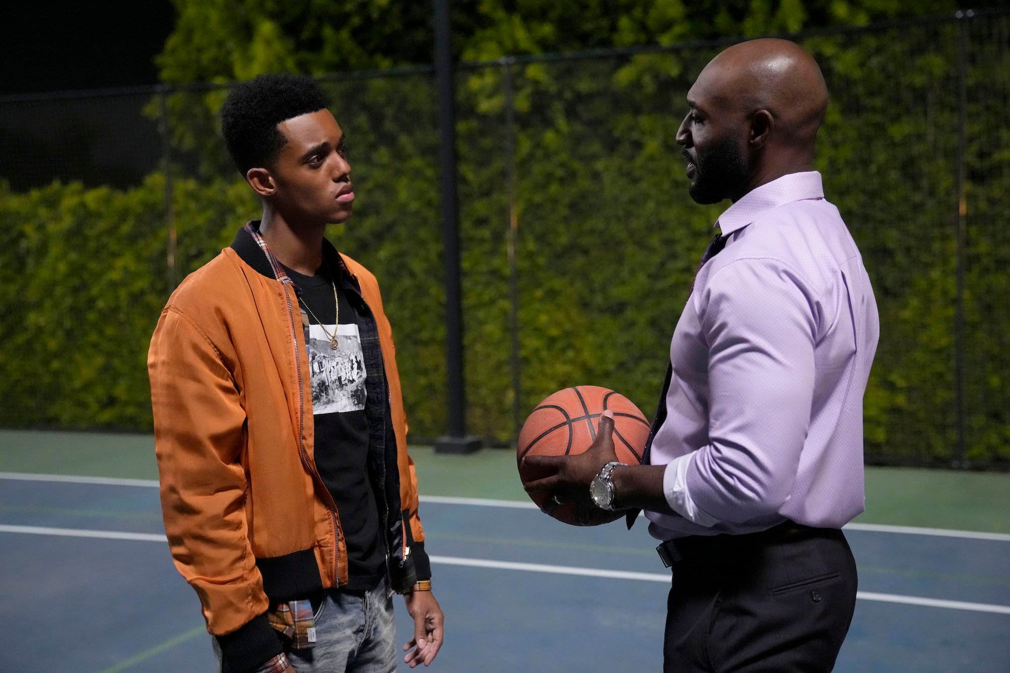 'Bel-Air' Uncle Phil Adrian Holmes holds a basketball and speaks to Jabari Banks as Will