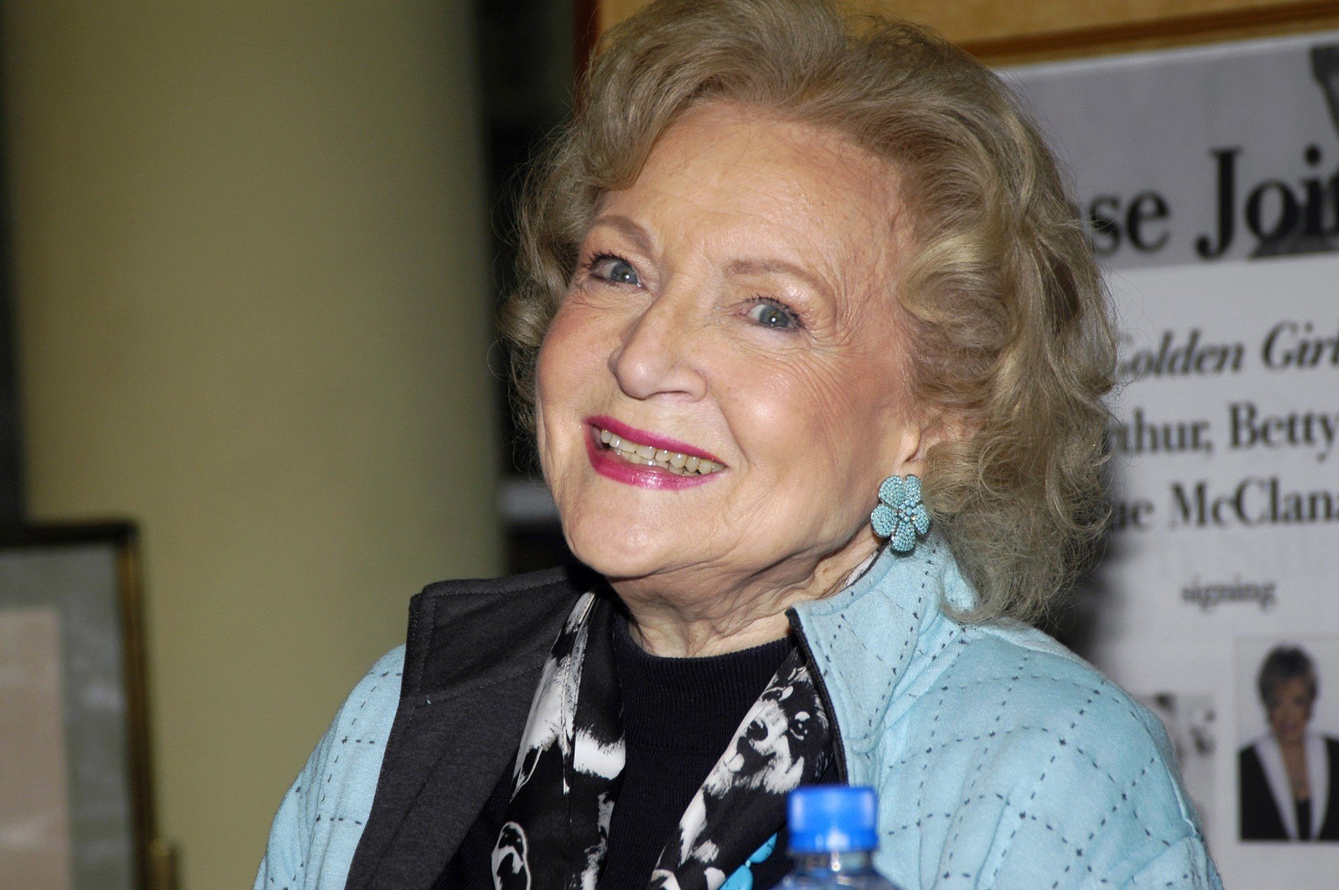 Betty White smiles while wearing a powder blue jacket
