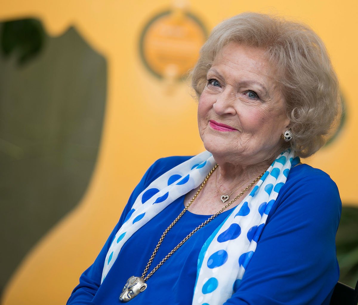Betty White wears blue and a white and blue scarf
