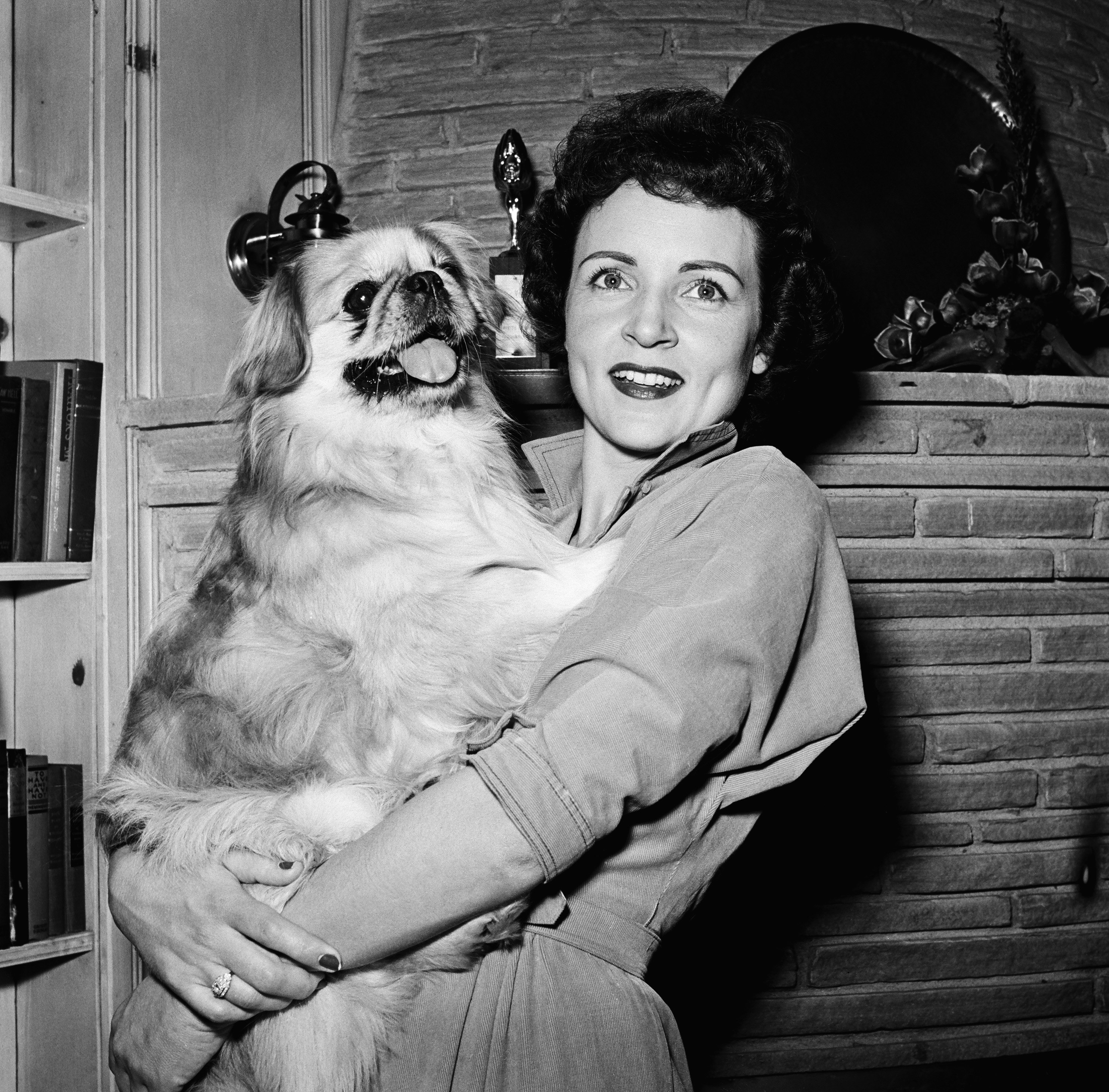 Betty White holds a dog