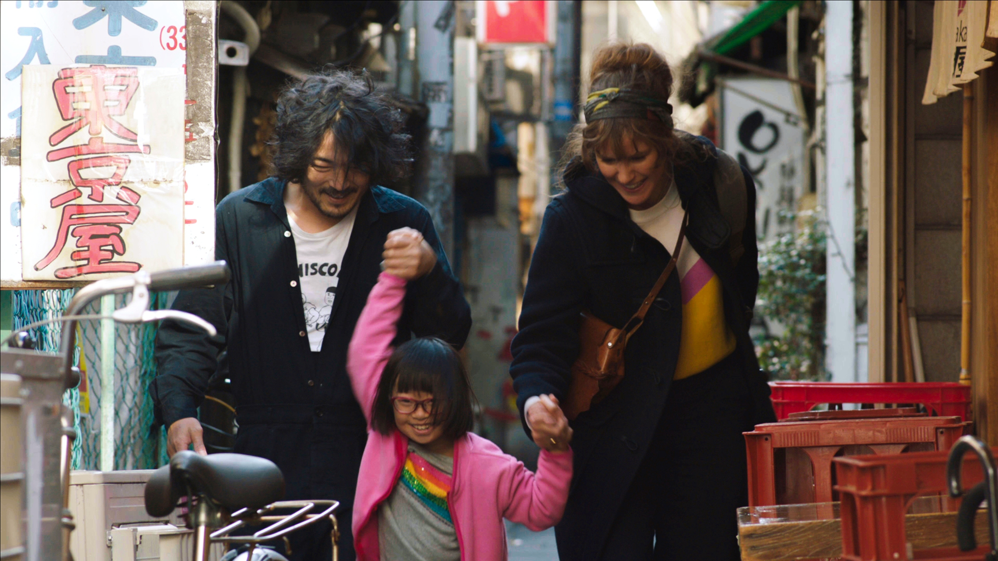 'Blood' review Takashi Ueno as Toshi and Carla Juri as Chloe holding hands of young girl walking on path