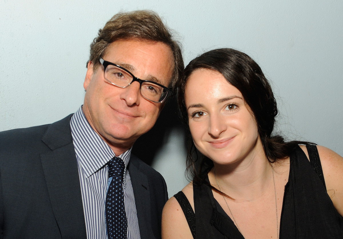 Bob Saget and Lara Saget smile and pose together at an event.