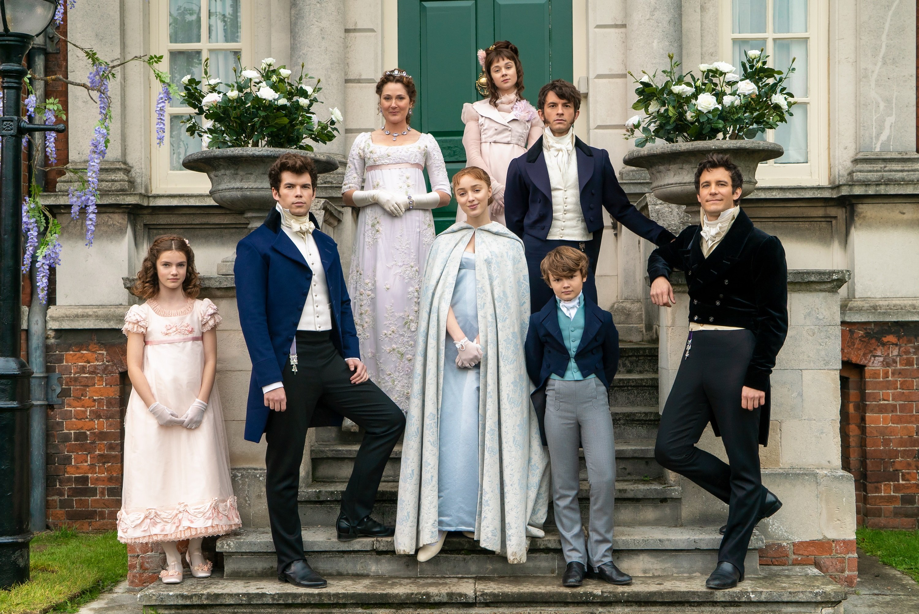 The 'Bridgerton' siblings pose for the camera with their mother from left to right: Florence Hunt as Hyacinth, Luke Newton as Colin, Ruth Gemmell as Lady Violet Bridgerton, Phoebe Dynevor as Daphne, Claudia Jessie as Eloise, Jonathan Bailey as Anthony, Will Tilston as Gregory, and Luke Thompson as Benedict.