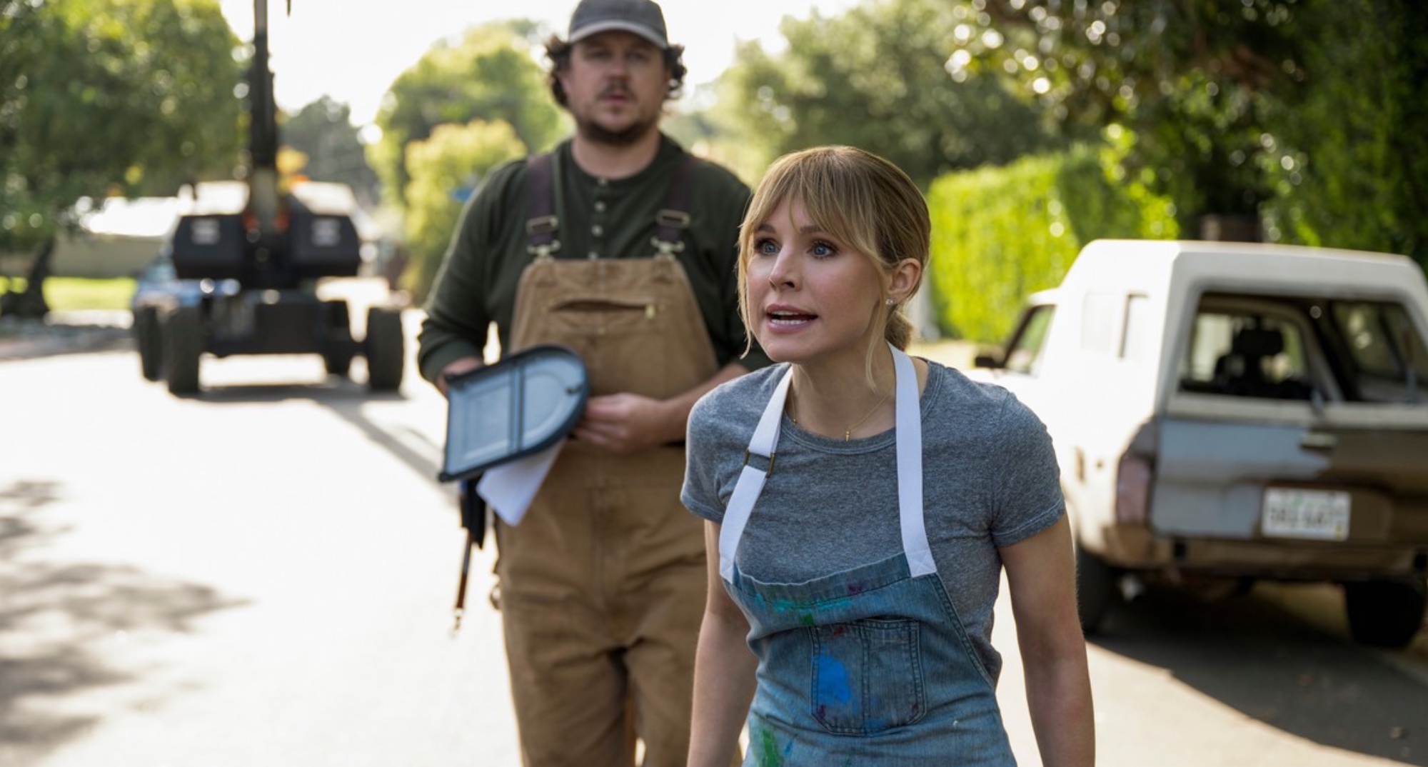 Buell and Anna from 'The Woman in the House Across the Street from the Girl in the Window' wearing work overalls outside.