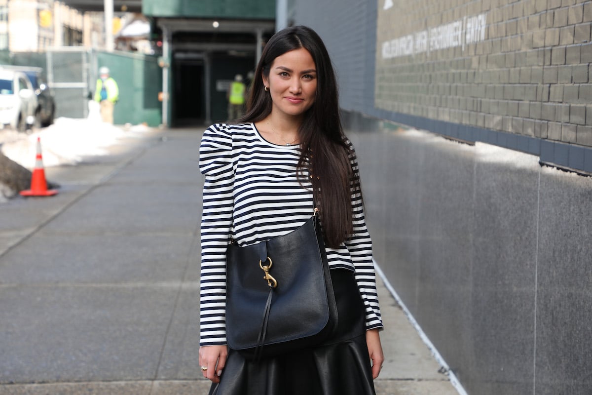 Caila Quinn wears a striped top as she poses for a photo outside the Rebecca Minkoff Fall 2021 fashion show