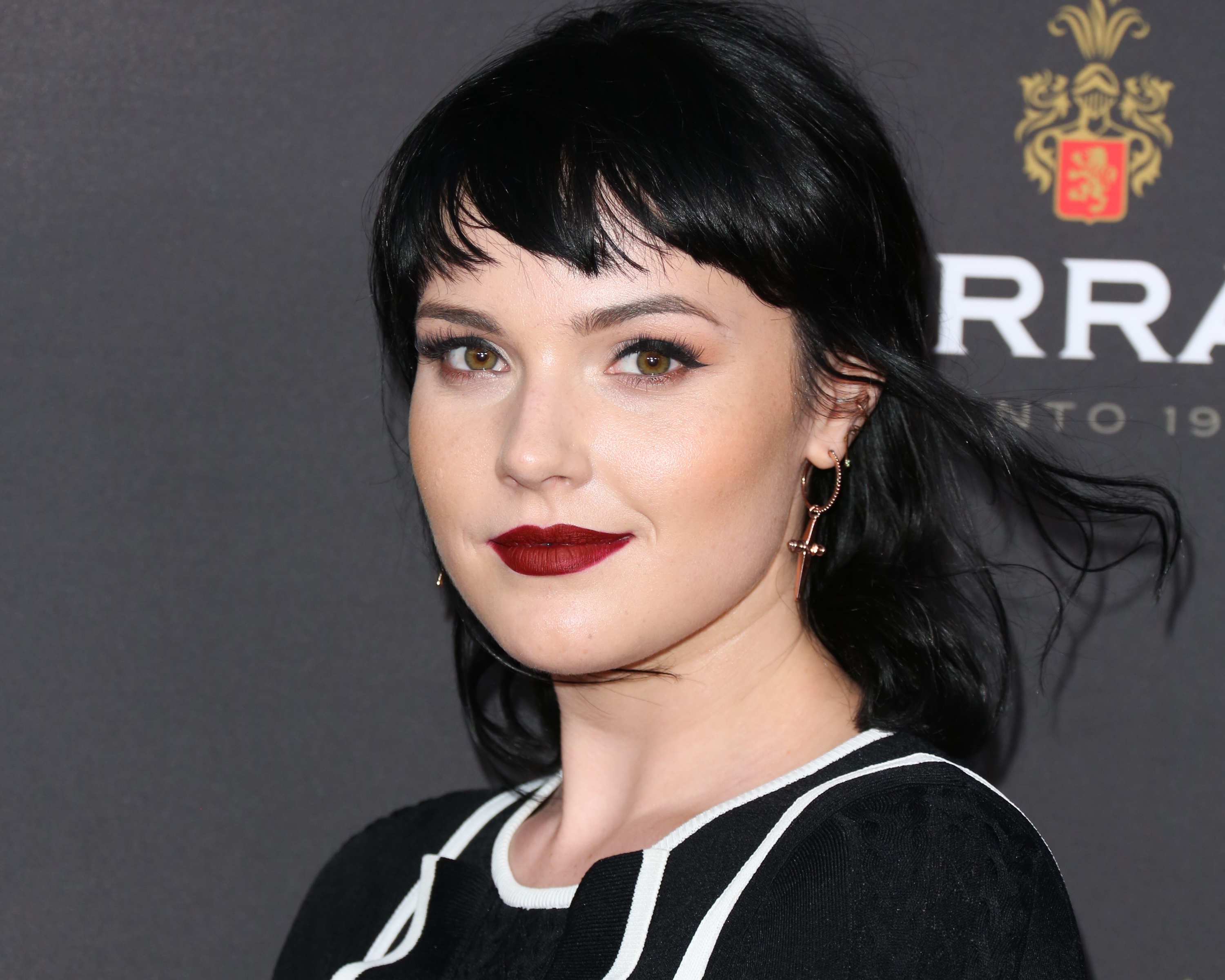 'The Young and the Restless' actor Cait Fairbanks wearing a black and white dress, and red lipstick.
