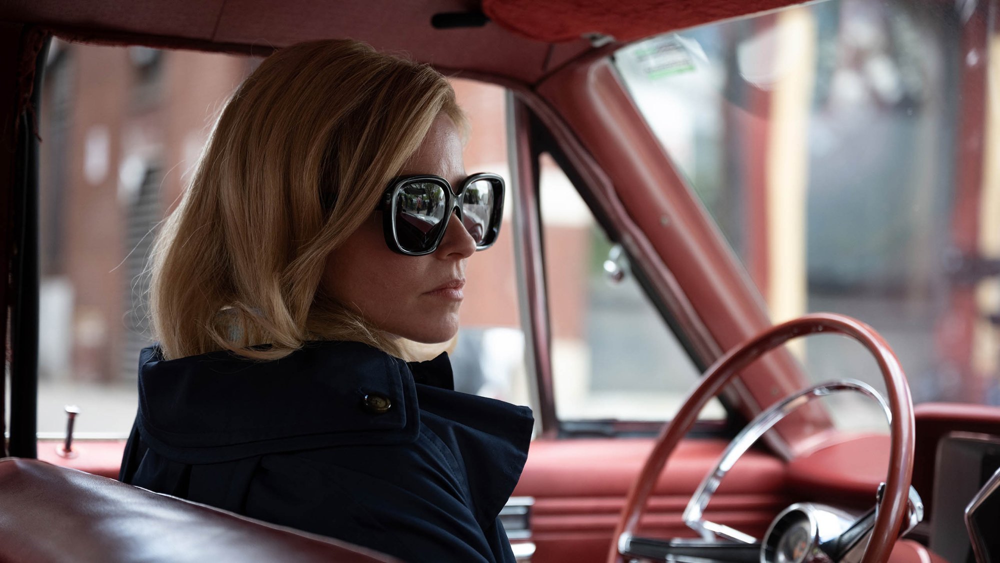 'Call Jane' review Elizabeth Banks as Joy wearing sunglasses sitting in the driver's seat of a car