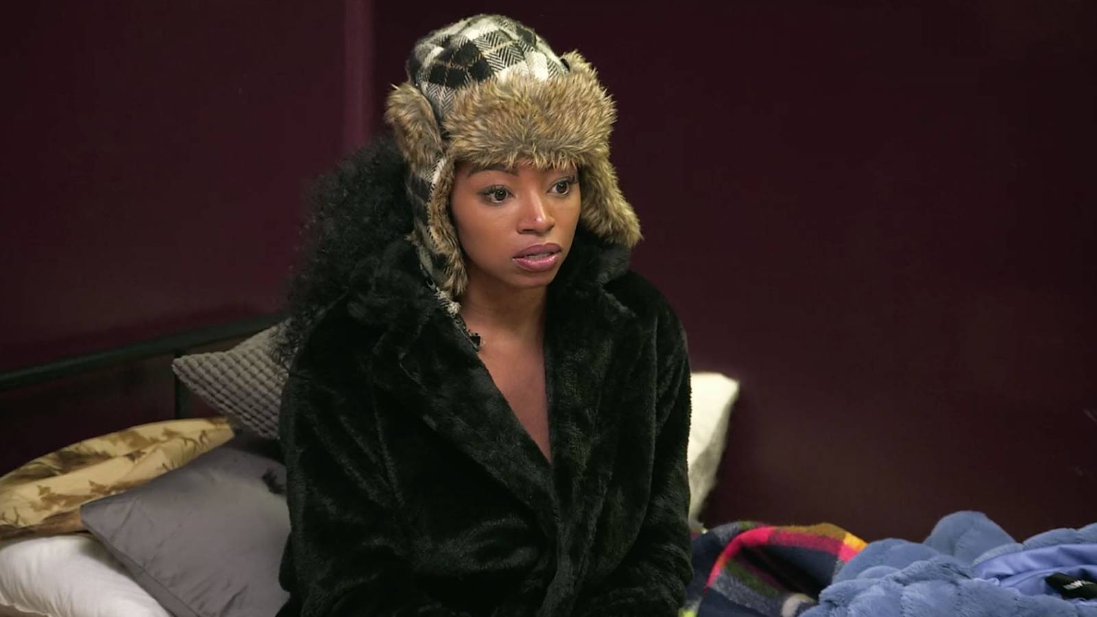 'Floribama Shore' star Candace Rice sitting on a bed wearing a hat