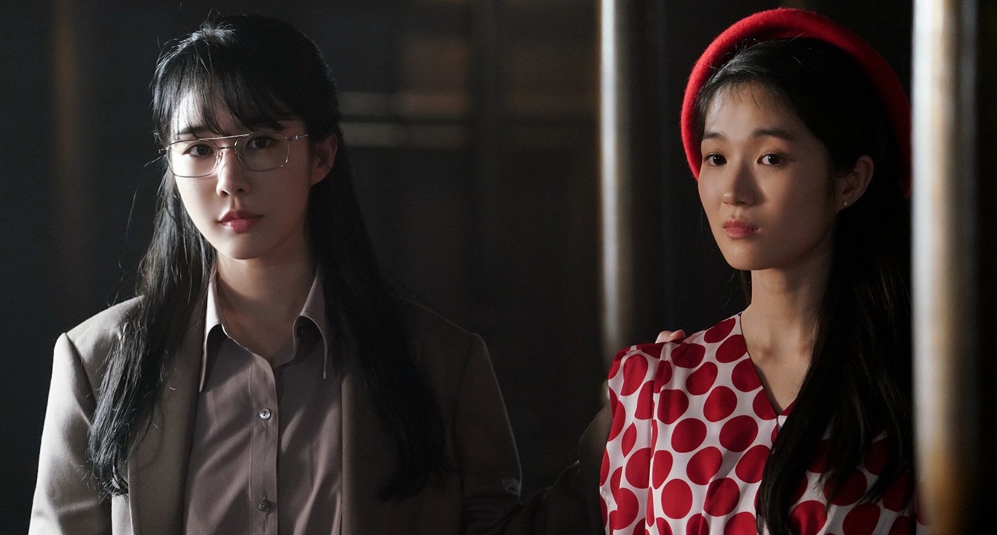Cast members Yoo In-na and Kim Hye-yoon in 'Snowdrop' wearing suit and red polka dot dress.