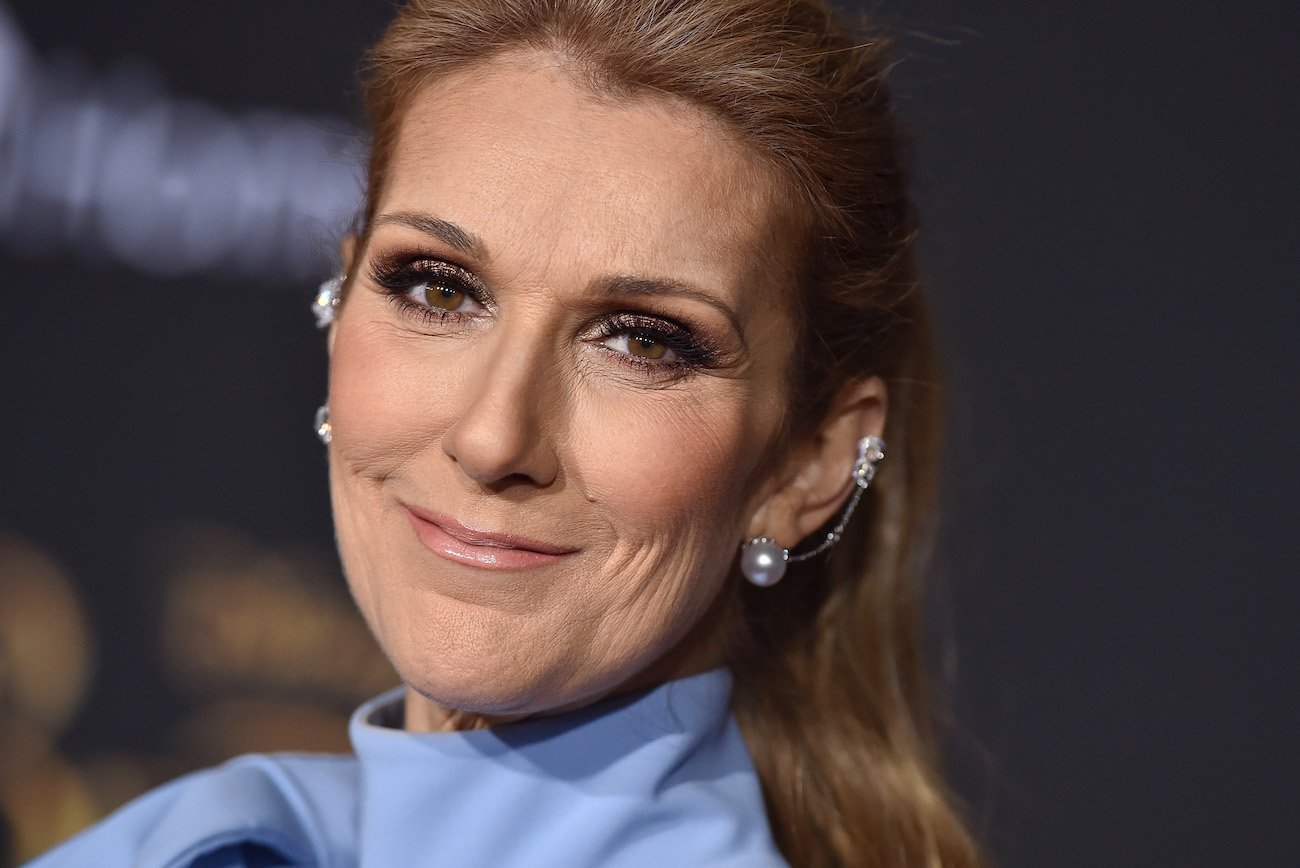 Céline Dion wearing periwinkle and smiling