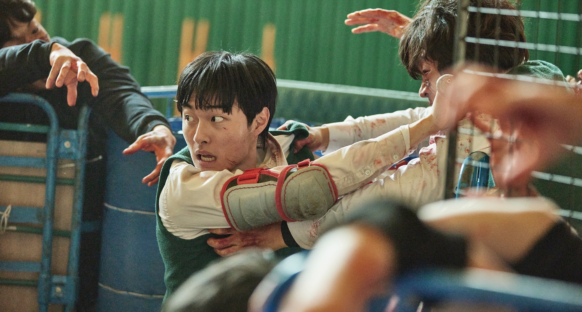 Character Chung-san in 'All of Us Are Dead' K-drama wearing school uniform fighting zombies.