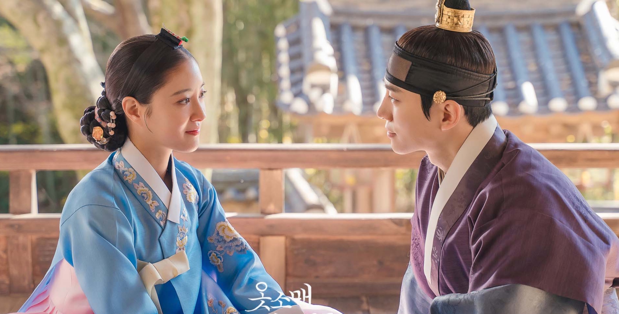 Characters Deok-im and Yi San in 'The Red Sleeve' finale wearing traditional hanbok.