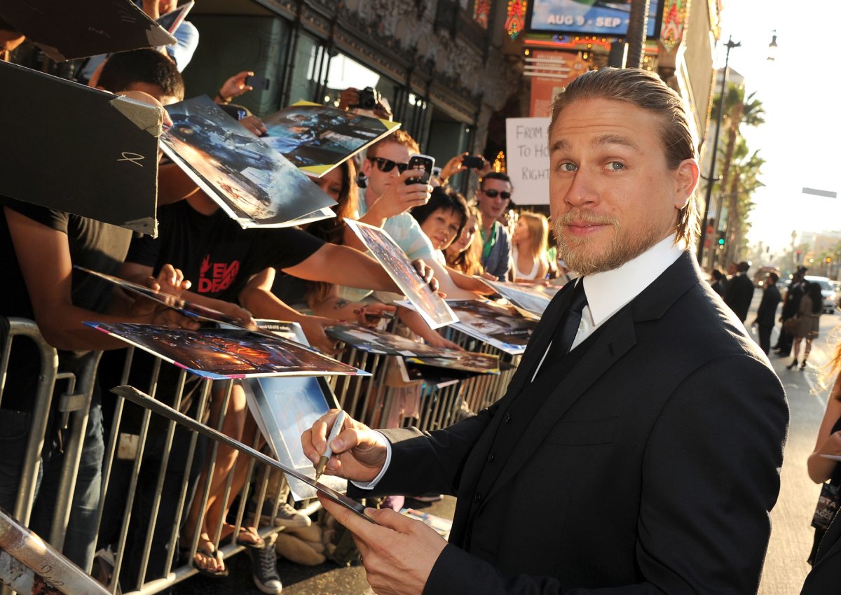 Sons of Anarchy star Charlie Hunnam in a three-piece suit signing autographs at the premiere of Warner Bros. Pictures' and Legendary Pictures' "Pacific Rim" at Dolby Theatre on July 9, 2013