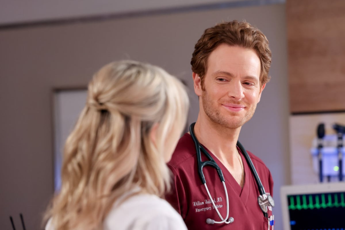 Kristin Hager as Dr. Stevie Hammer and Nick Gehlfuss as Dr. Will Halstead in Chicago Med Season 7. Halstead smiles at Hammer.