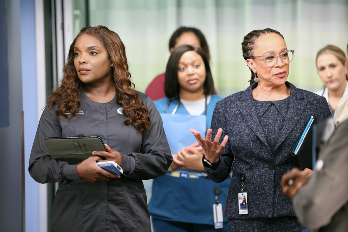 Marlyne Barrett as Maggie and S. Epatha Merkerson as Sharon Goodwin in Chicago Med Season 7. Maggie and Goodwin stand next to each other in the hospital.