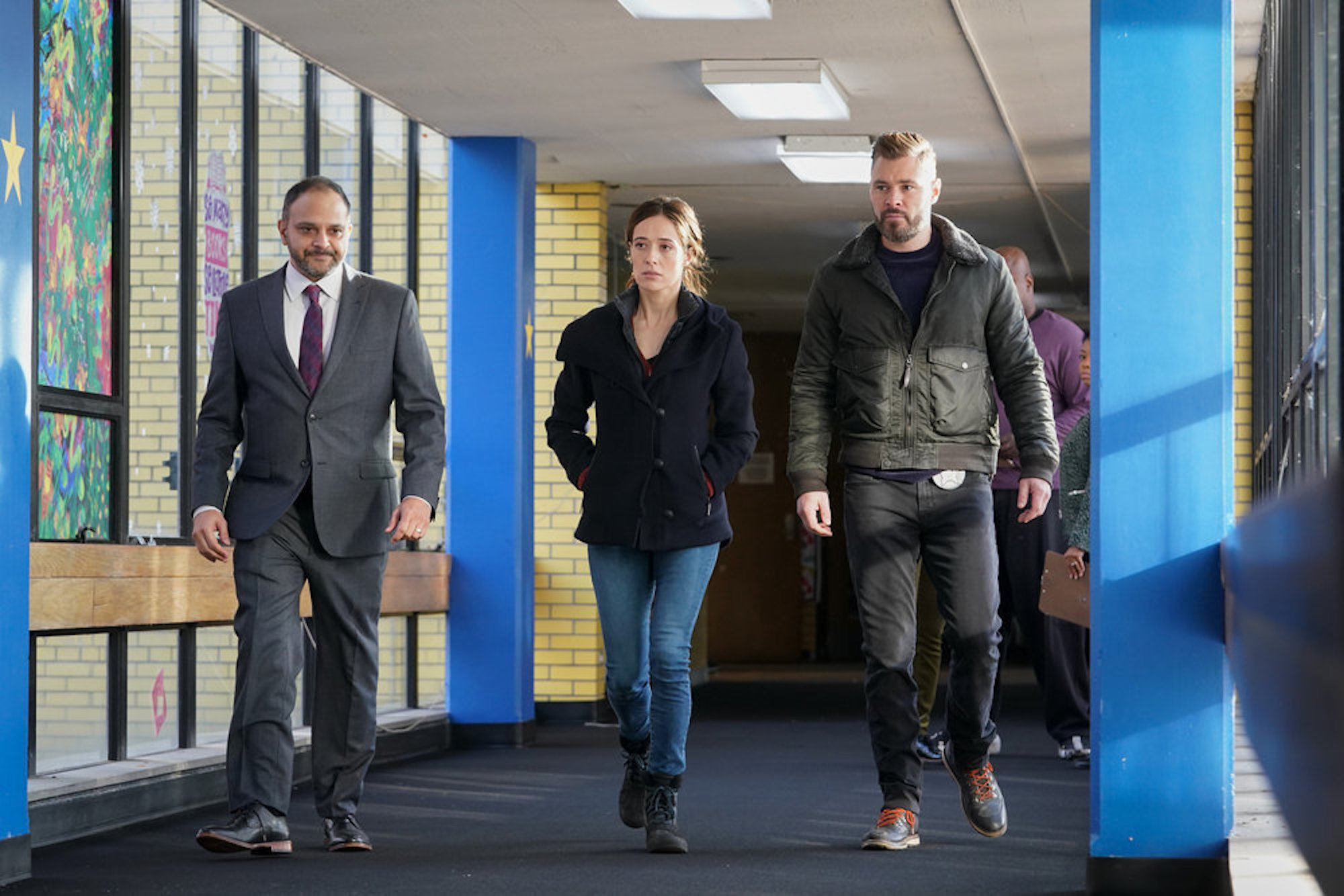 Marina Squerciati as Kim Burgess and Patrick John Flueger as Adam Ruzek walking next to each other in 'Chicago P.D.' Season 9 Episode 10