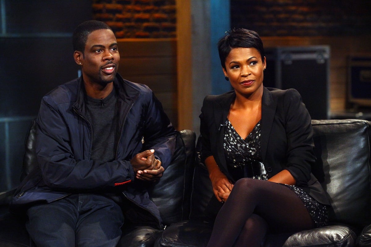 Chris Rock and Nia Long sitting next to each other.