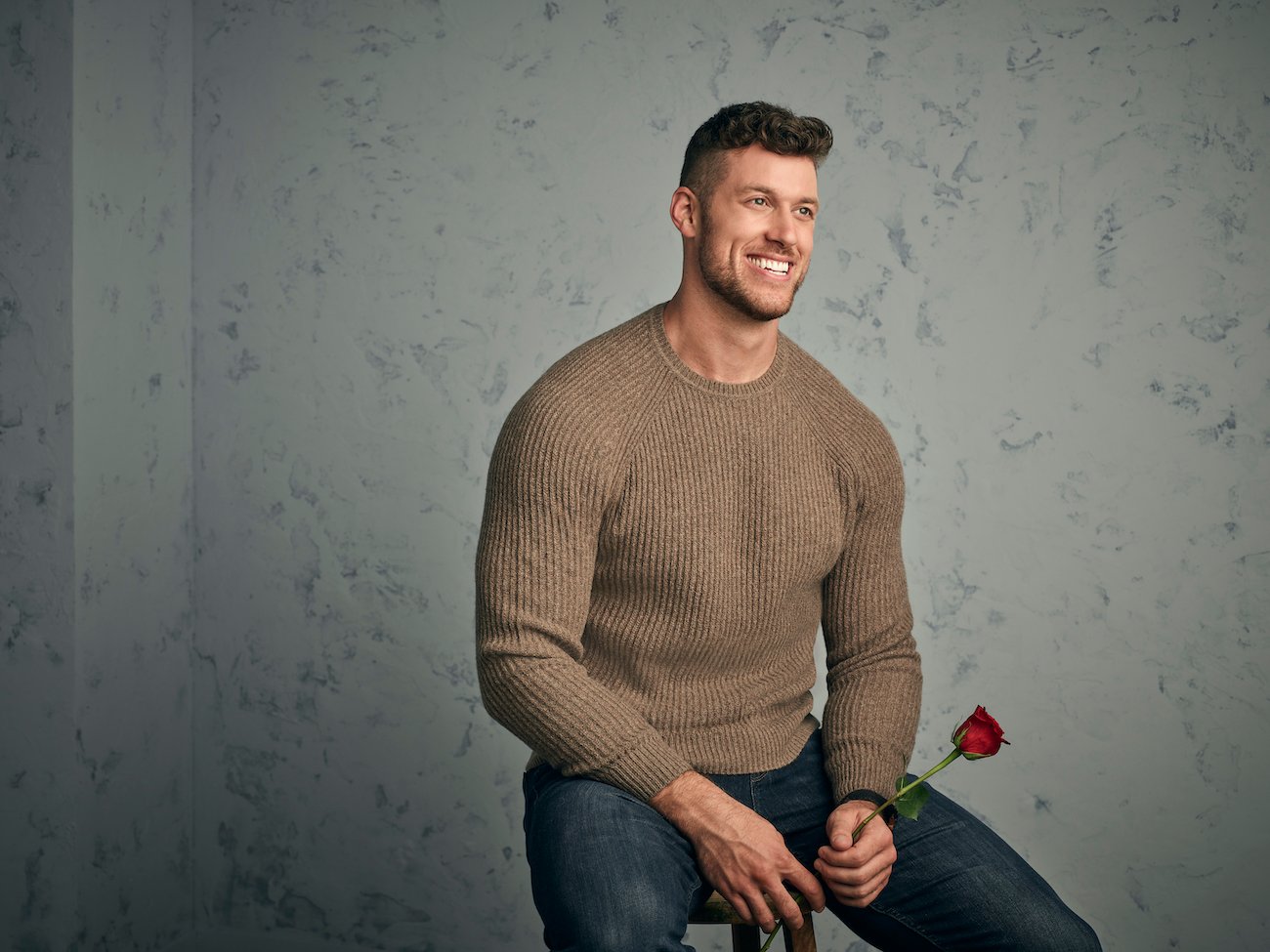'The Bachelor' Clayton Echard poses holding a rose