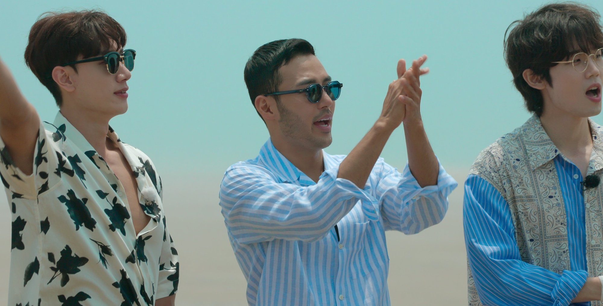 Contestants for 'Single's Inferno' finale on Netflix wearing summer shirts on beach.