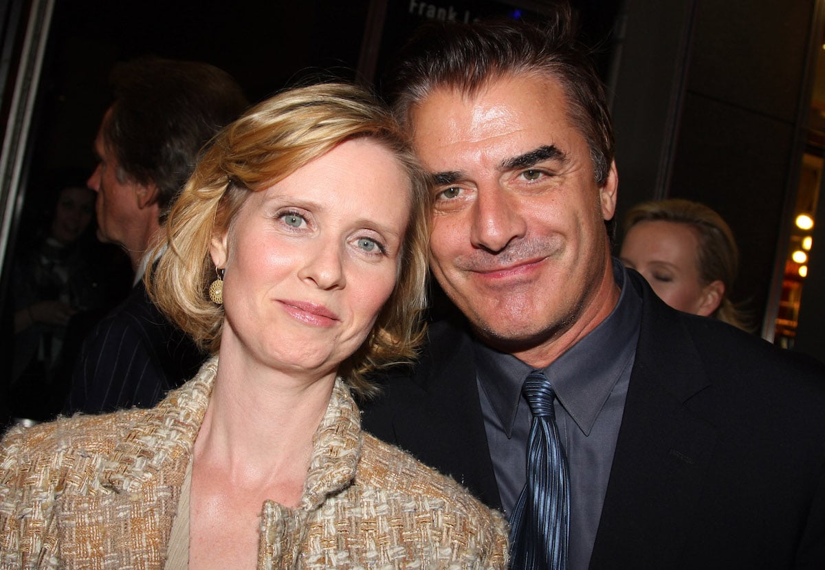 Cynthia Nixon and Chris Noth smile and pose together.