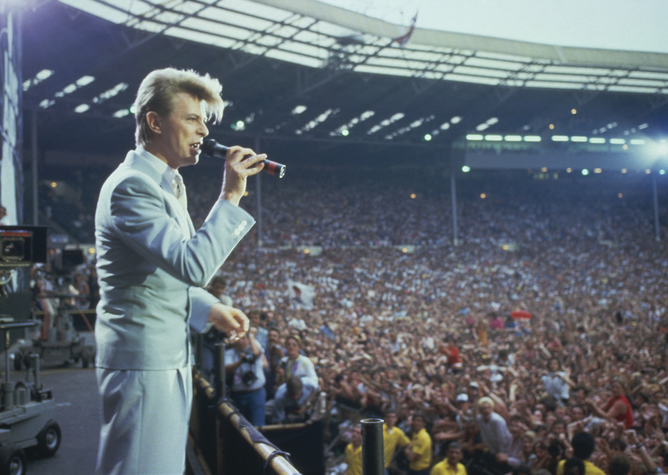 David Bowie performing in a suit at Live Aid, London, 1985.