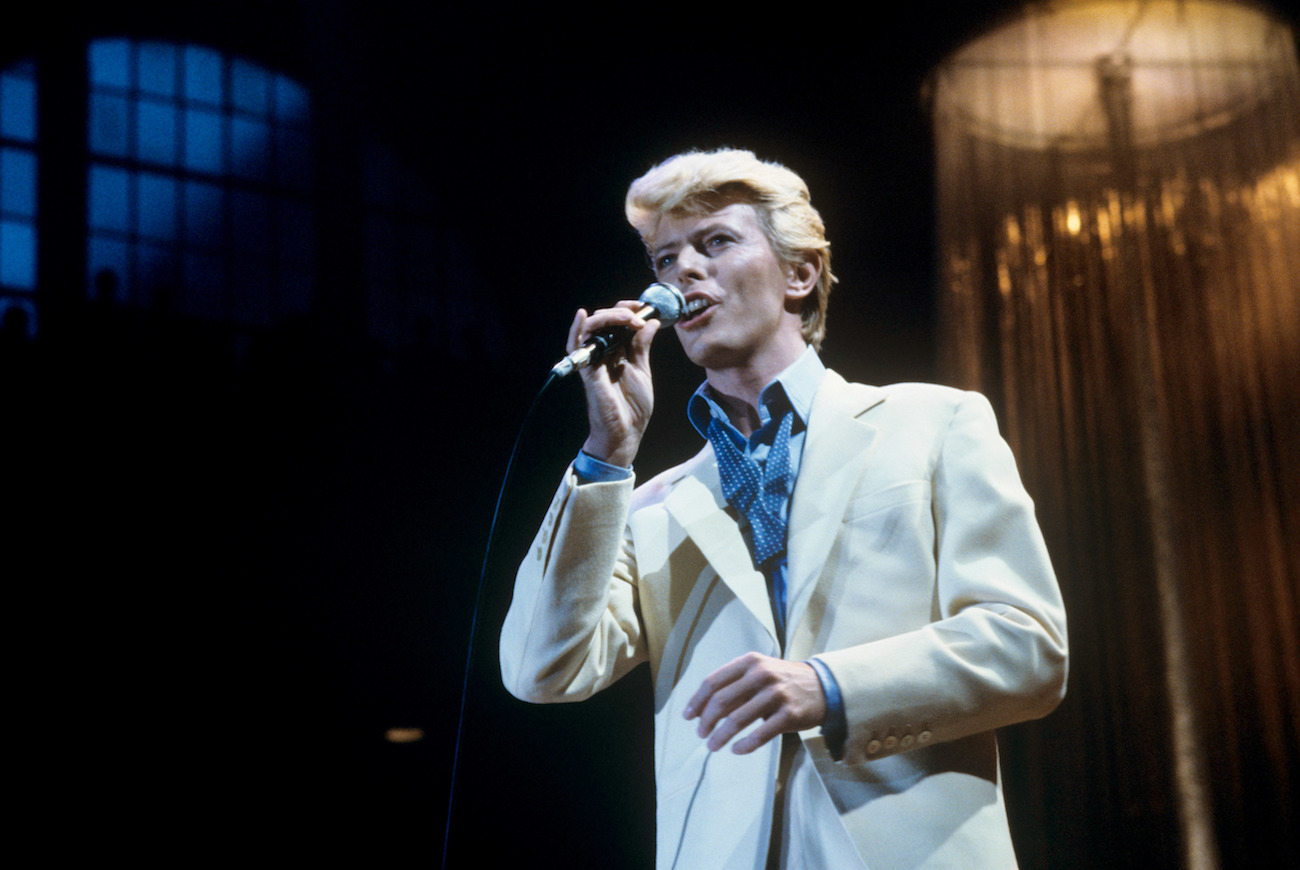 David Bowie performing in a white suit in Frankfurt, Germany, 1983.