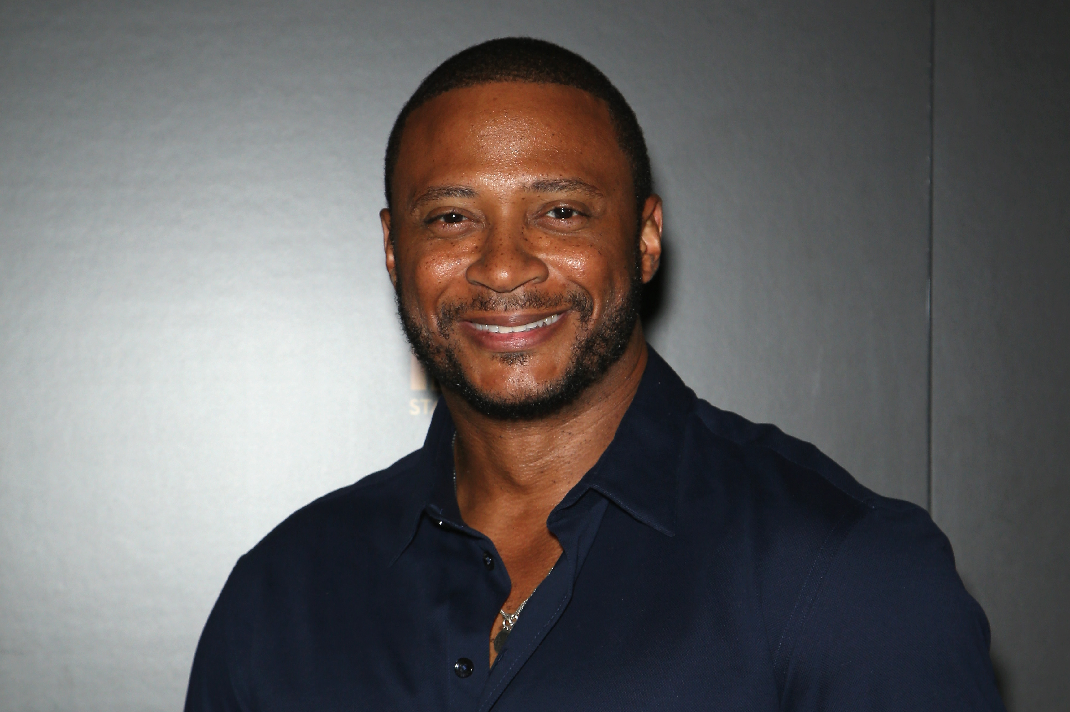 'Arrow' star David Ramsey, who played John Diggle in the show, wears a dark blue long-sleeved button-down shirt.
