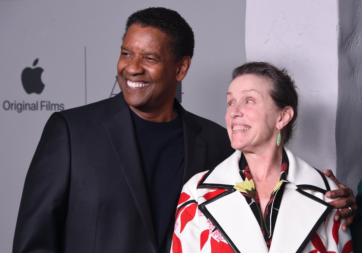 Denzel Washington and Frances McDormand smile and look off-camera on the red carpet