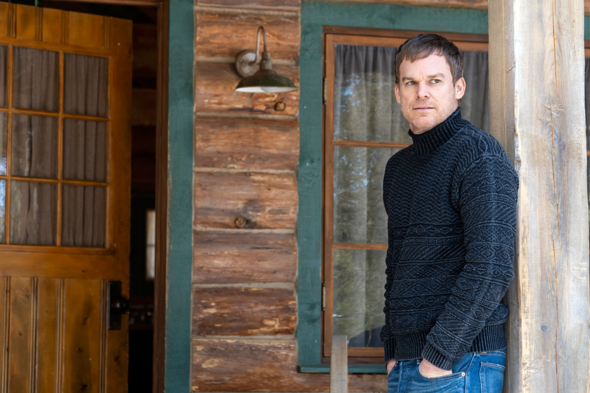 Michael C. Hall as Dexter in Dexter: New Blood. Dexter stands on the front porch of his cabin.
