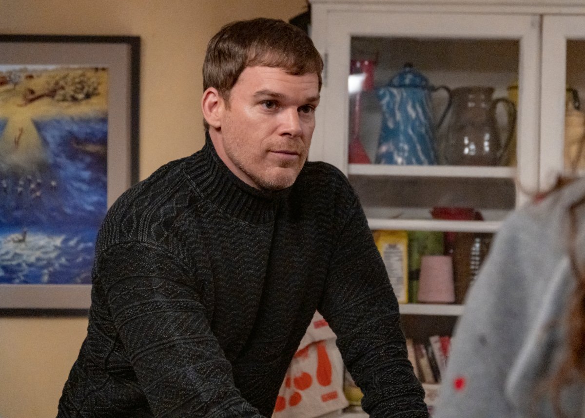 Michael C. Hall as Dexter in Dexter: New Blood. Dexter stands in the kitchen wearing a turtleneck sweater.