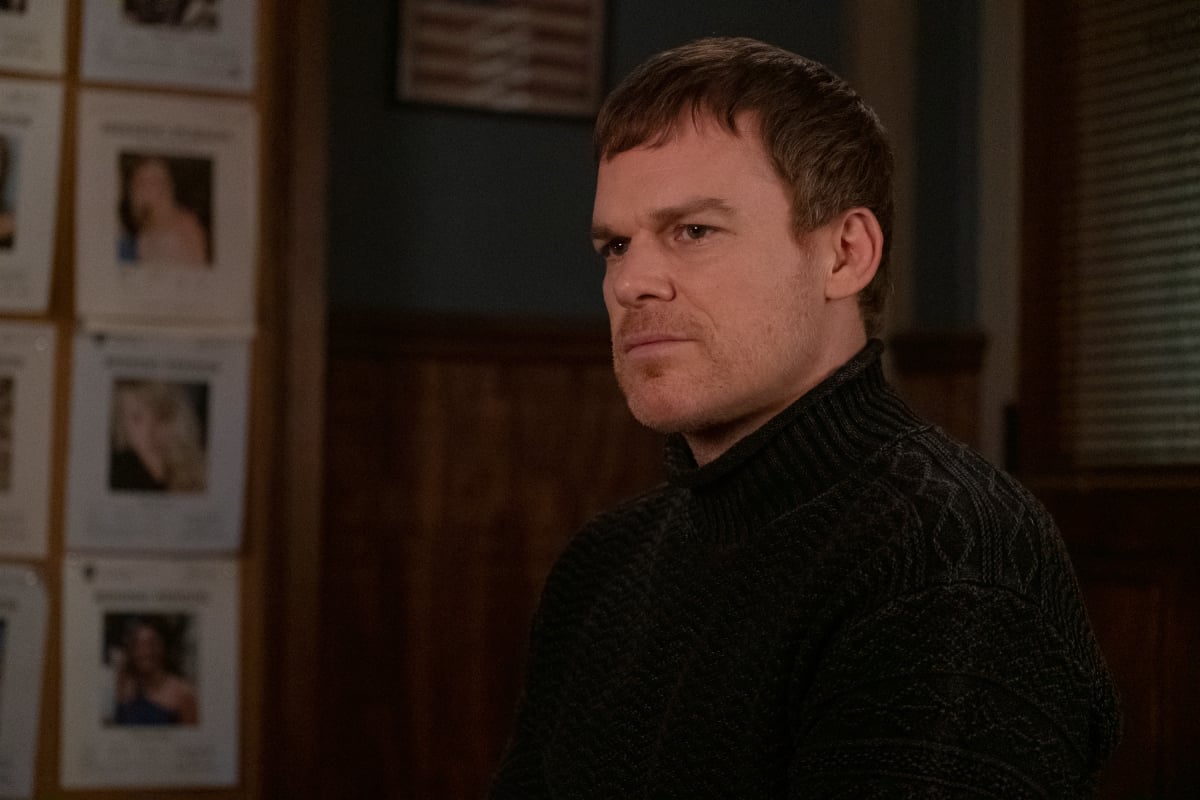Michael C. Hall as Dexter in the Dexter: New Blood finale. Dexter sits at the police station wearing a turtleneck sweater.