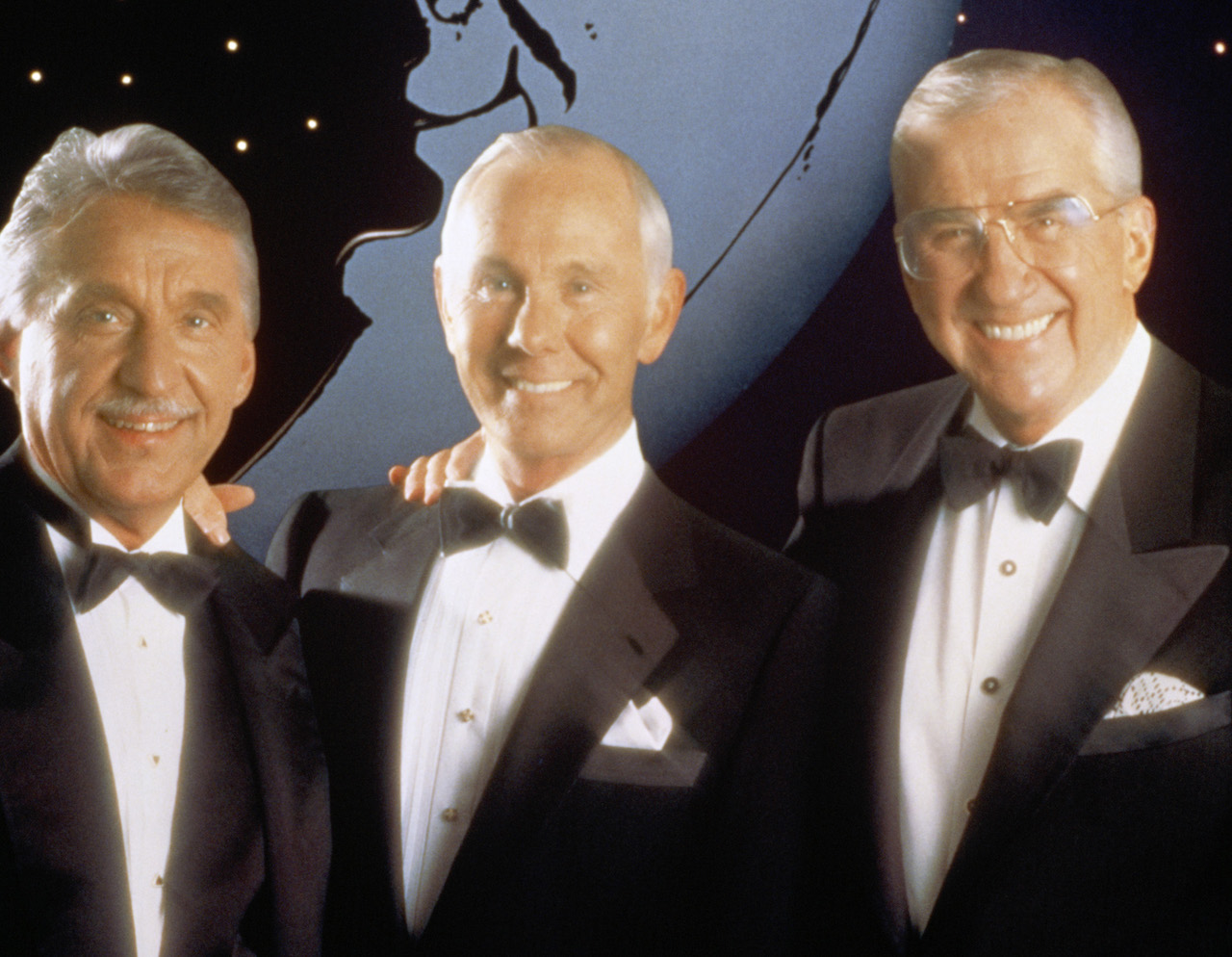 'The Tonight Show' Band leader Doc Severinsen, host Johnny Carson, co-host Ed McMahon in black and white tuxedoes