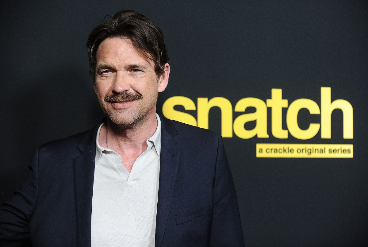 Dougray Scott smiling with a mustache.