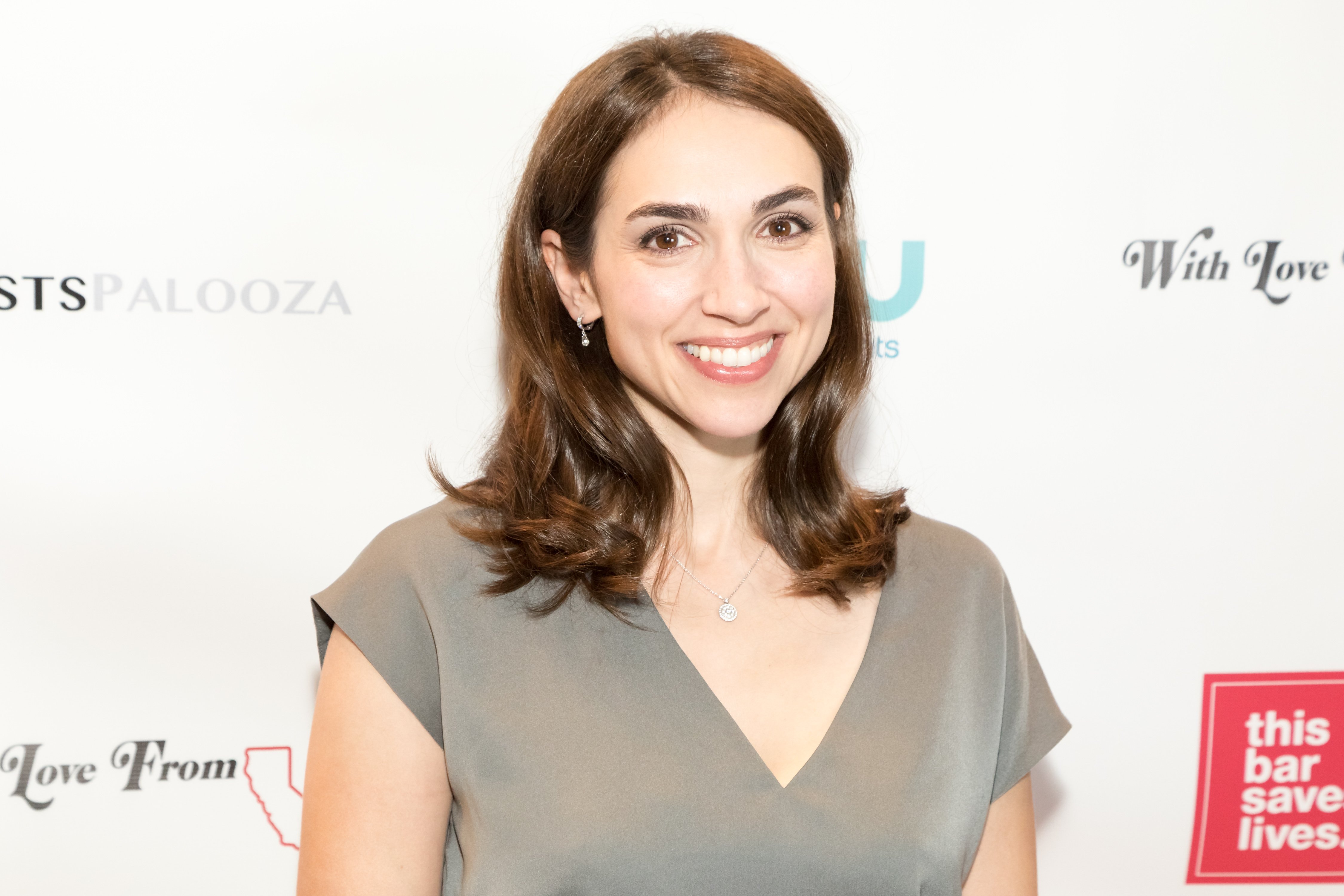 'The Young and the Restless' actor Eden Riegel wearing a grey dress during a red carpet appearance.