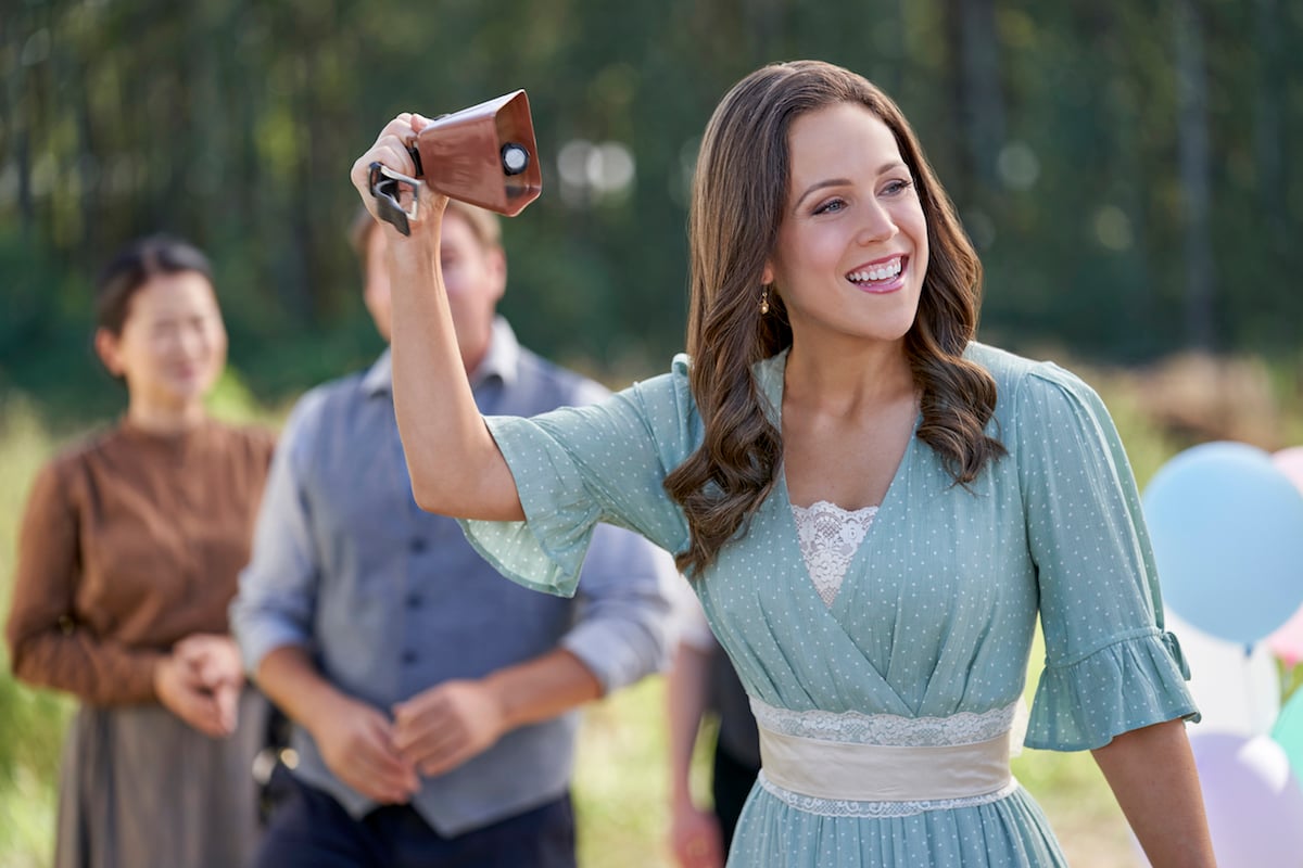 Elizabeth (Erin Krakow) ringing a bell in an episode of 'When Calls the Heart' Season 8