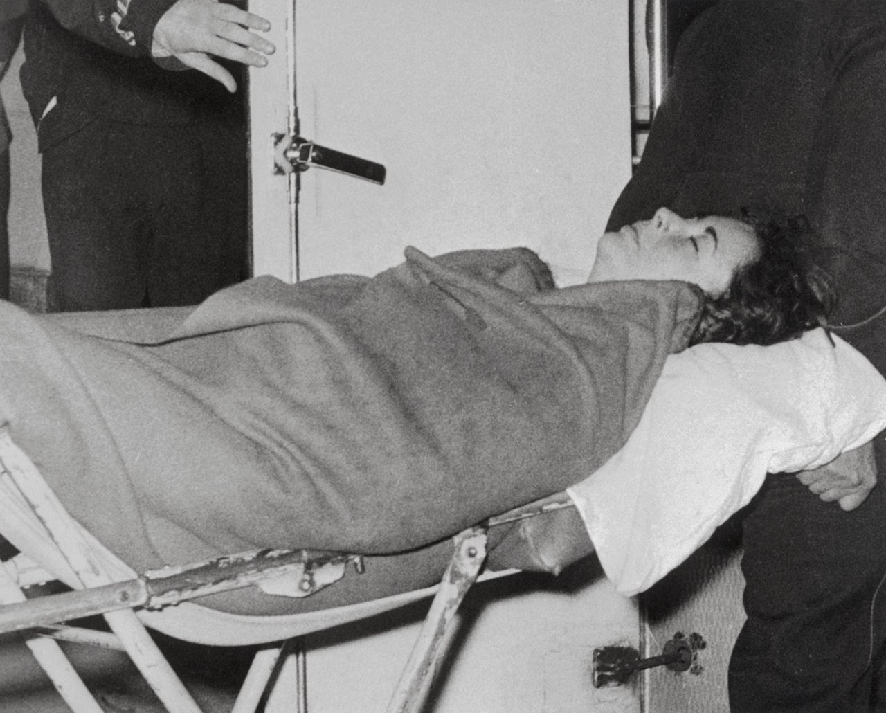 Elizabeth Taylor is carried by stretcher into a London hospital where she received treatment for pneumonia in 1961